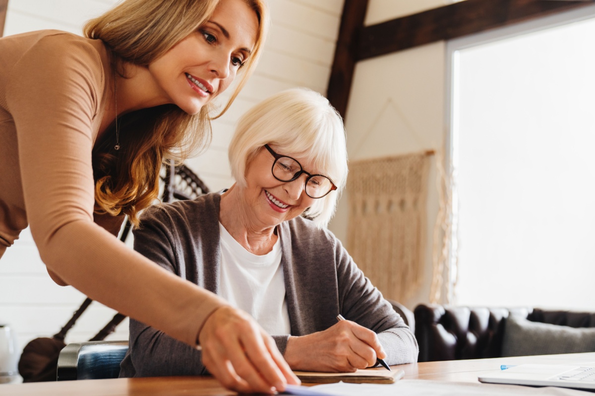 Female financial adviser helping senior woman