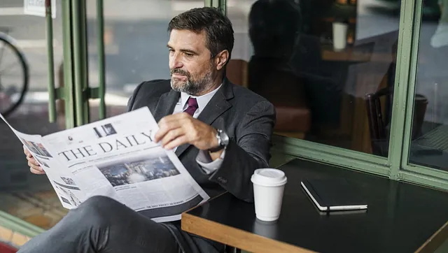 A business owner reading a paper