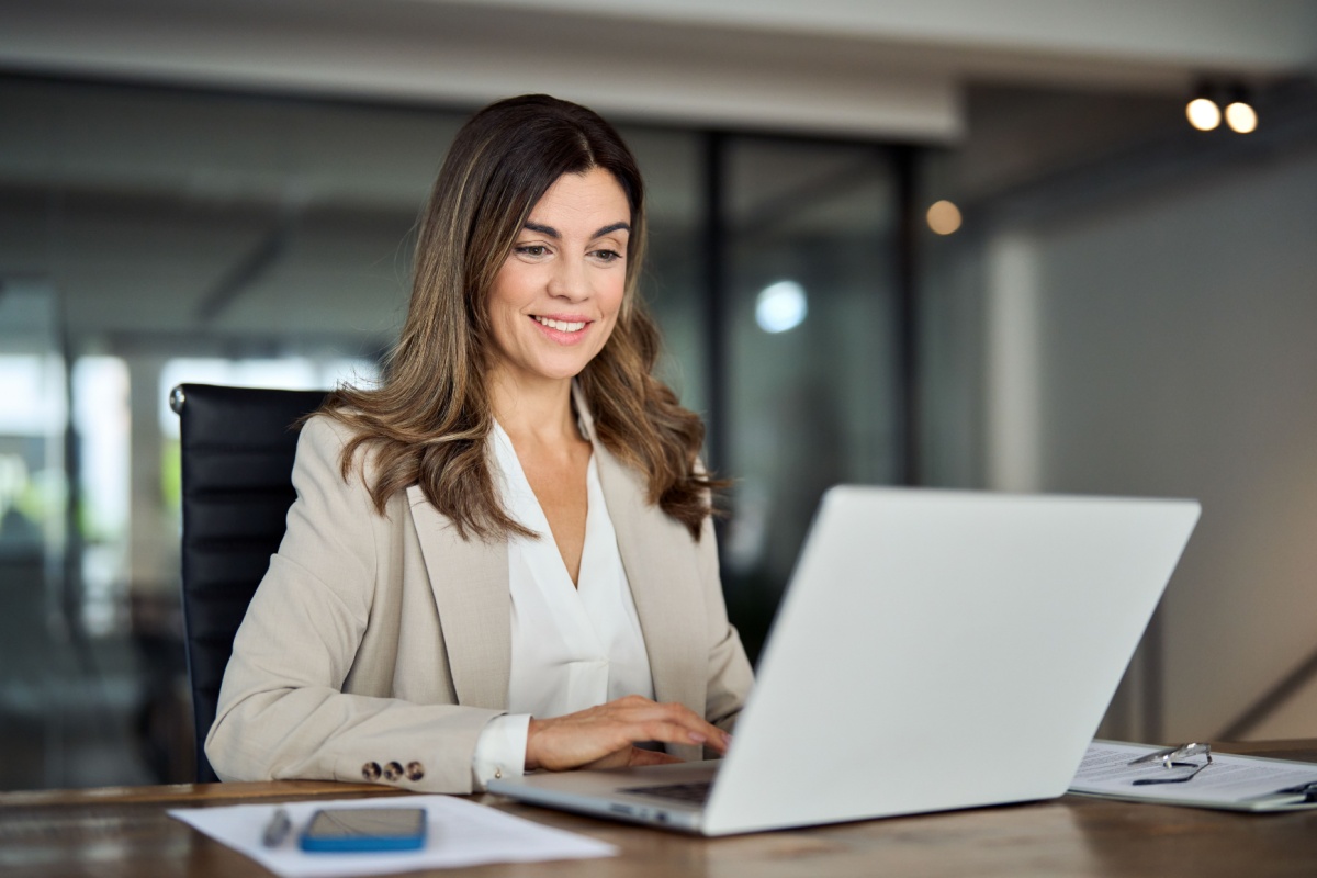 Smiling businesswoman working on a laptop