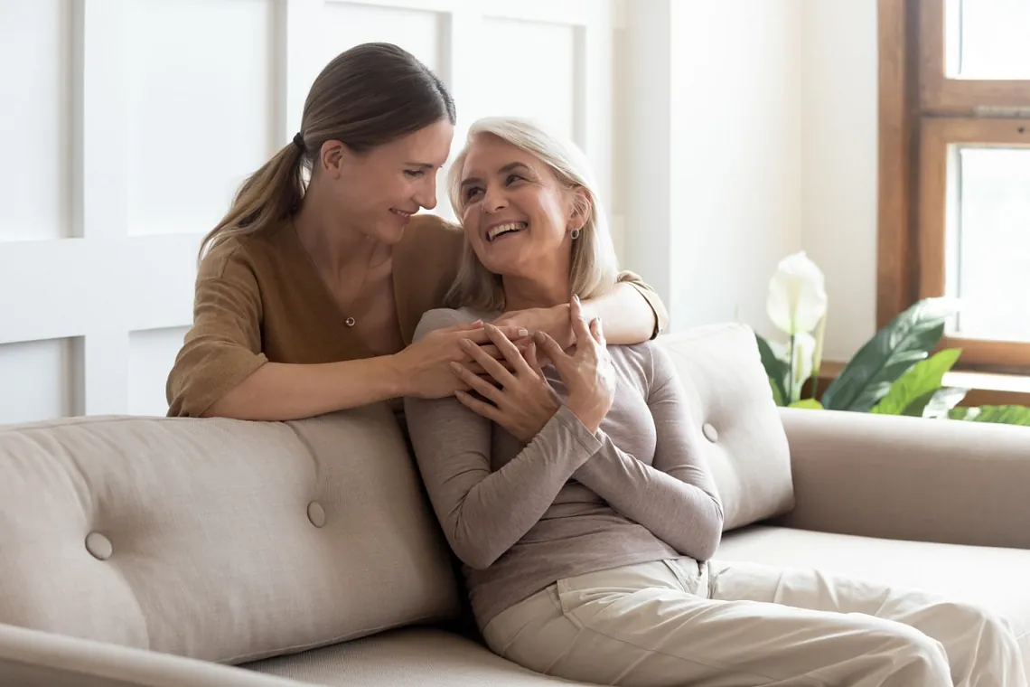 Adult daughter hugging mother